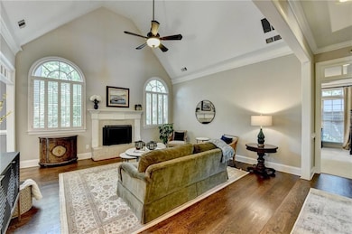 Living area with a high vaulted ceiling and fan, t