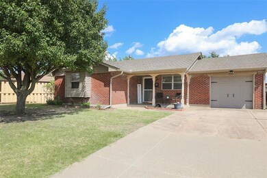Ranch-style house featuring a garage and a front y