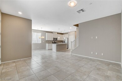 Unfurnished living room featuring light tile patte