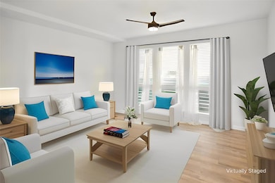 Living room with a ceiling fan, light wood-style 