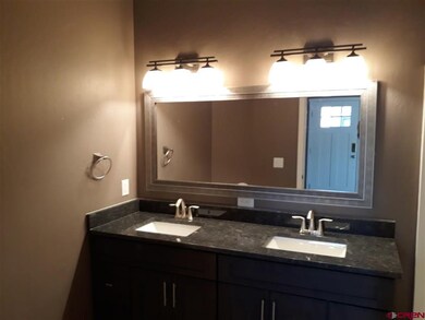 Second bath with double sinks and granite counter 