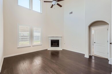Unfurnished living room featuring a high ceiling, 