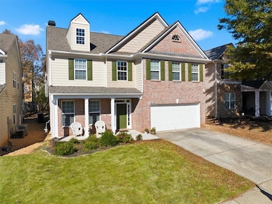 Craftsman-style house featuring driveway, a front yard, roof with shingles, covered porch, and an attached garage