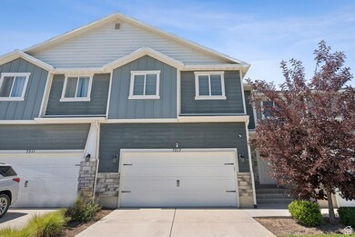Craftsman-style house with stone siding, board and batten siding, concrete driveway, and a garage