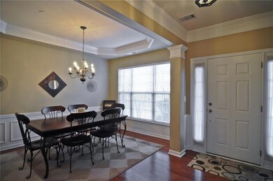 Formal dining room features wainscoting and trey ceiling