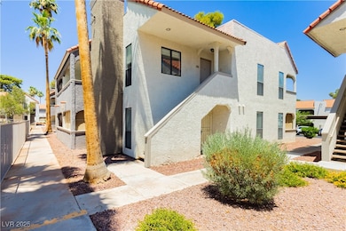 View of front of building with stucco siding, a ti