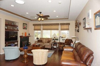 Big great room with wood floors, coffered ceiling 