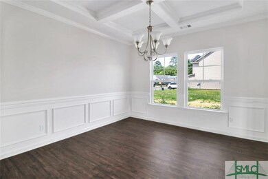 Formal dining room with coffered ceilings, crown m