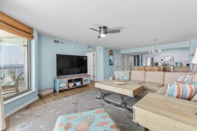 Living room with a textured ceiling, light hardwoo