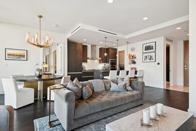 Living room featuring a chandelier and dark hardwo