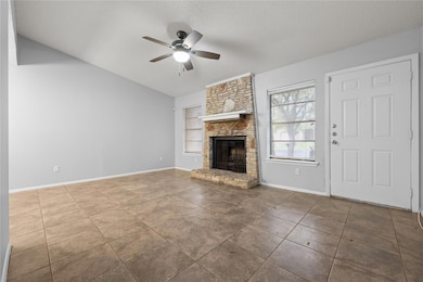 Unfurnished living room with baseboards, a firepl