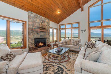 Living room featuring a stone fireplace, a mountai