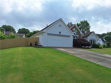 View of front of property with a garage, fence, a 