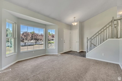 Foyer with carpet and stairway