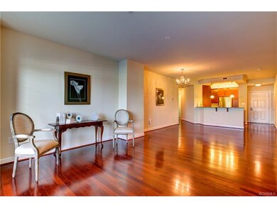 View of living space, kitchen, and hallway to left