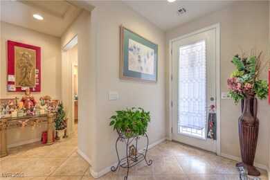 Foyer entrance with recessed lighting, light tile