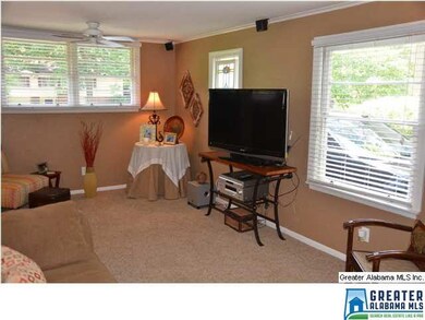 The bonus room has big windows and cozy carpeting.