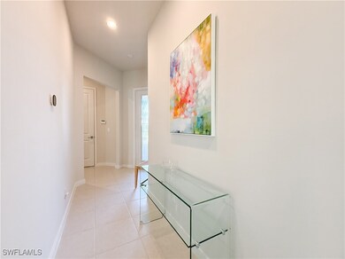 Hall featuring light tile patterned flooring