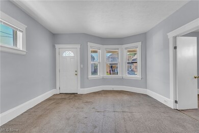 Entrance foyer with a healthy amount of sunlight, a textured ceiling, and carpet floors