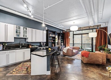 Kitchen featuring dark countertops, concrete floo