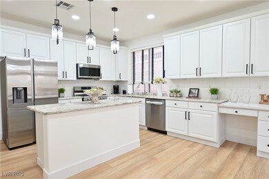 Kitchen with light wood-type flooring, visible ven