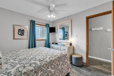 Bedroom with baseboards, a textured ceiling, wood 