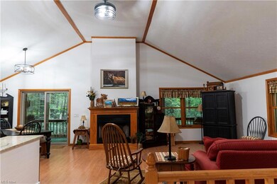 Living room featuring crown molding, light hardwoo