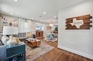Living room featuring wood finished floors, baseb