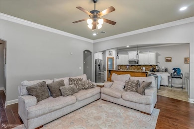 Living room with ceiling fan, hardwood / wood-styl