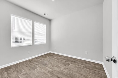 Spare room with wood finished floors and baseboards