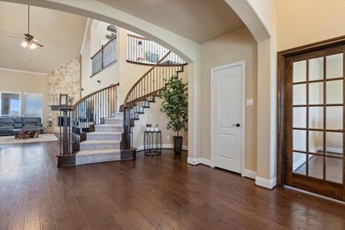 The elegant foyer offers french doors leading into