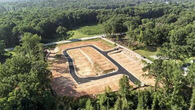 Aerial overview of property's location with a heavily wooded area