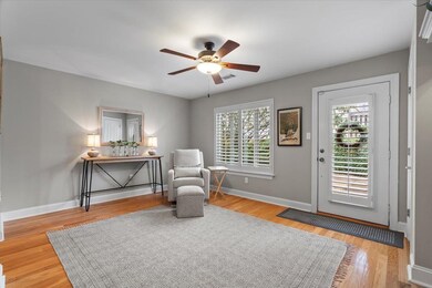Living area with ceiling fan, a wealth of natural 