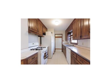 KITCHEN VIEW FROM EATING SPACE/DOORWAY INTO FRONT 