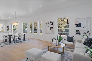 Living room with a chandelier, wood finished floo