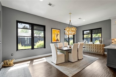 This dining area functions beautifully for everyday and entertaining. It is a versatile space, perfect for both casual meals and special occasions, offering a comfortable and inviting atmosphere for all gatherings.
