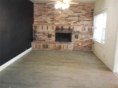 Unfurnished living room featuring ceiling fan and 