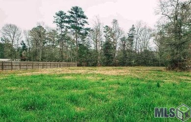 Fenced on one side and tree-lined in the back.