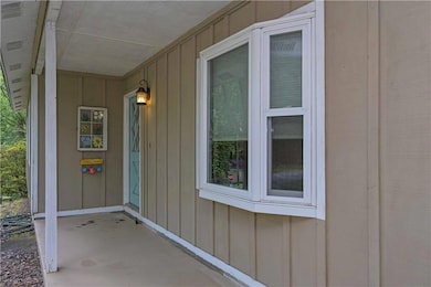 Property entrance featuring board and batten sidin