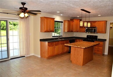 Newly renovated kitchen features oak cabinets, stainless appliances, new lighting, new countertops and ceramic flooring. Plenty of room to eat at the Island, by the glass sliding patio door to look outdoors, or simply retire to the adjoining dining r