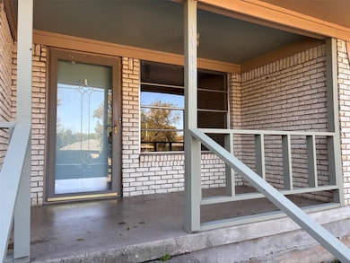 Doorway to property with brick siding