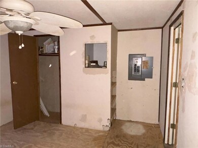 Second bedroom with built in shelves, closet and ceiling fan.