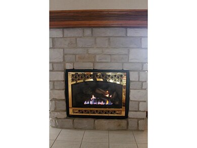 Other. Gas fireplace with wood mantle and custom g