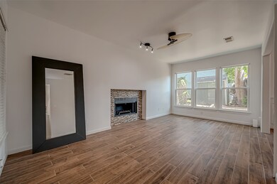 This spacious, well-lit living room has a fresh an