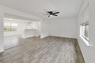 Unfurnished living room with light wood-type floo