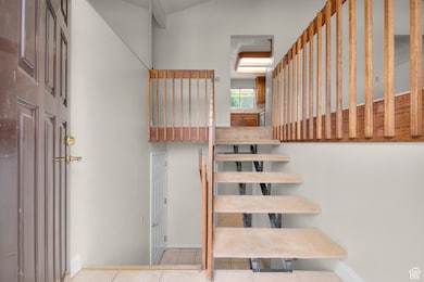 Stairway featuring tile patterned floors