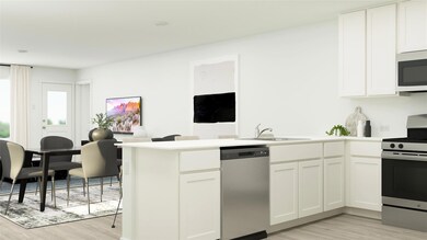 Kitchen featuring white cabinets, sink, light wood
