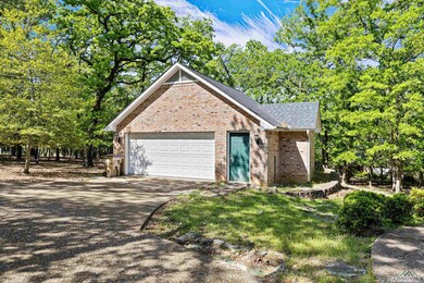 View of front of house featuring driveway, brick s