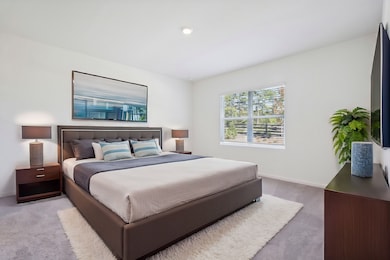 Carpeted bedroom with baseboards