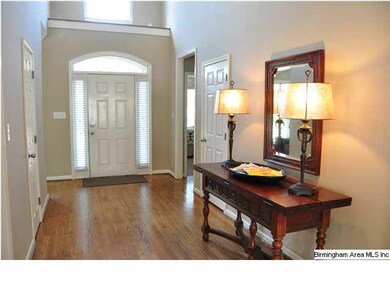 The welcoming entry is wide and open, with hardwoo